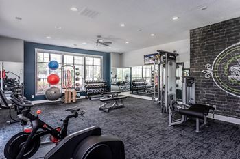 the gym at the district flats apartments in lenexa